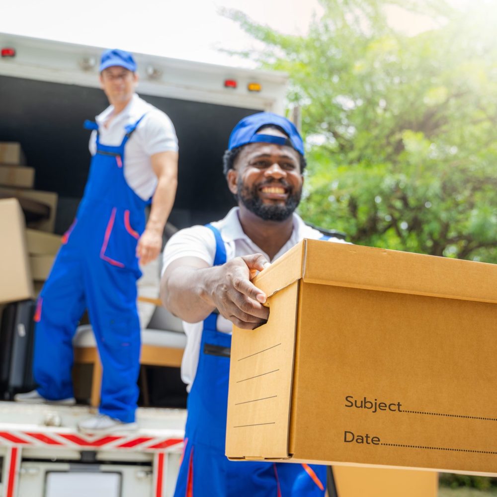 delivery-man-unloading-moving-boxes-from-car-min delivery-man-unloading-moving-boxes-from-car-min